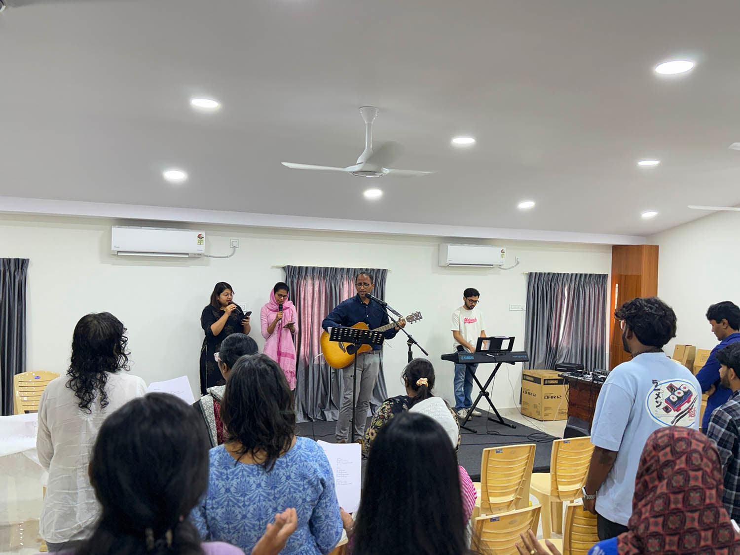 The worship team leading on guitar, keyboard and voice